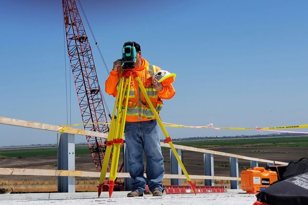 Surveyor carrying out a topographical survey on site